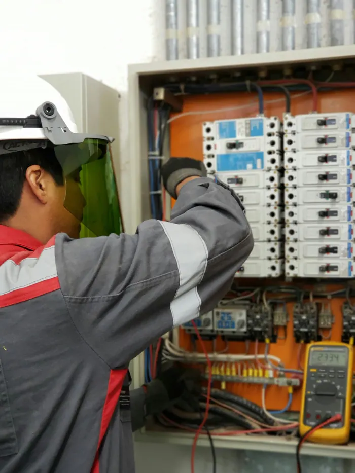 Field technician at an electrical panel
