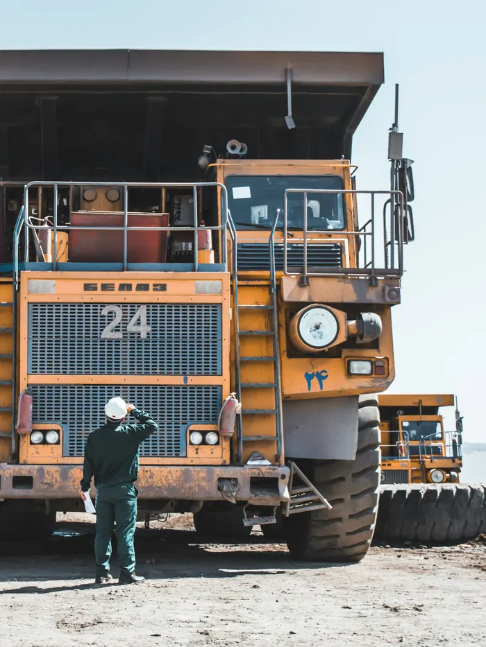 Mine worker beside a haul truck