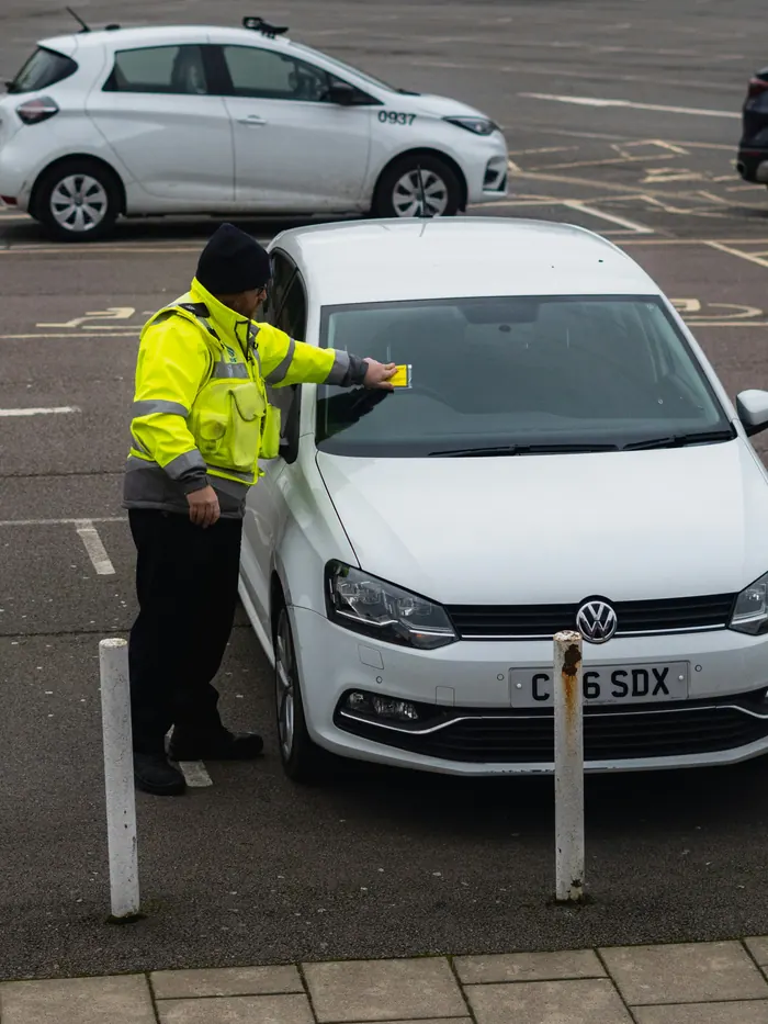 Parking attendant checking a vehicle