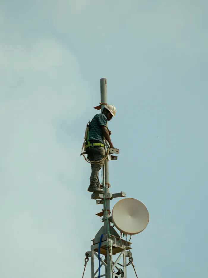 Technician climbing a telecom tower