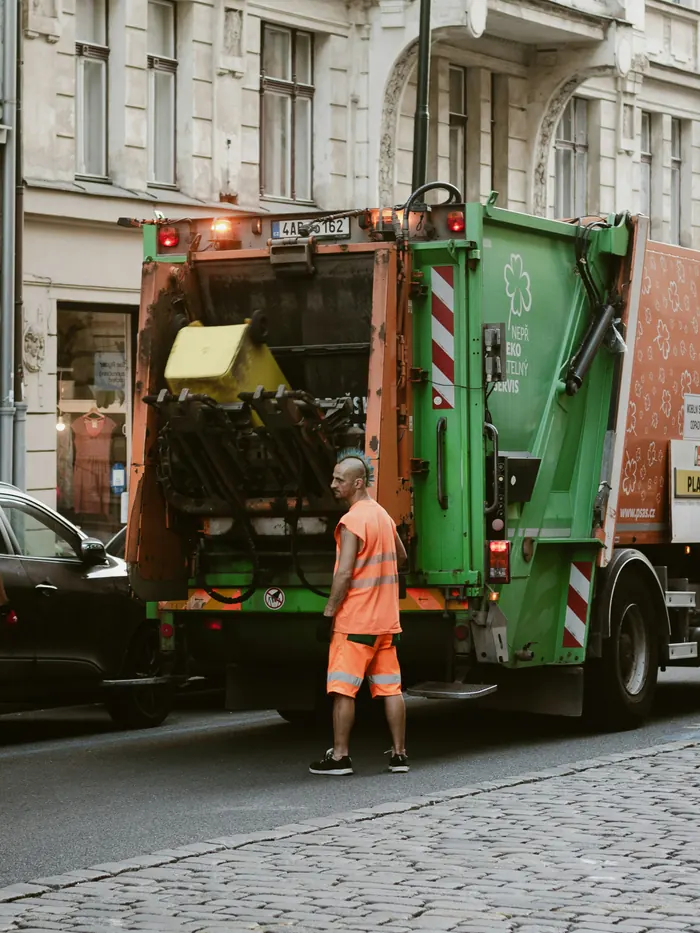 Refuse crew beside a collection truck